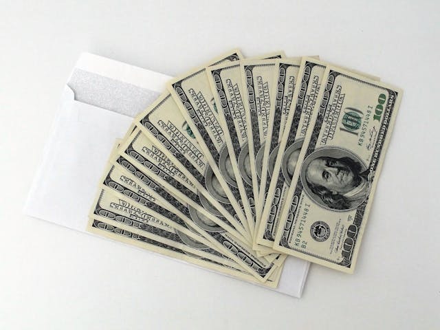 money sitting on white envelope