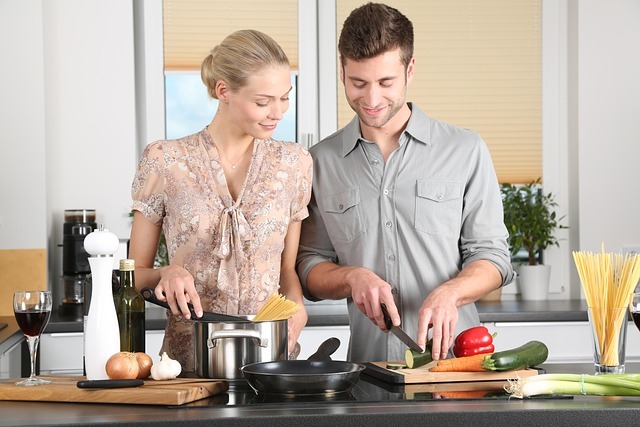 A tenant couple happily cooking in the kitchen together