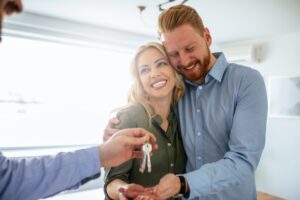 Couple receiving keys for their rental property.