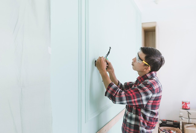 Paintenance man inspecting and working on electrical wiring with safety glasses