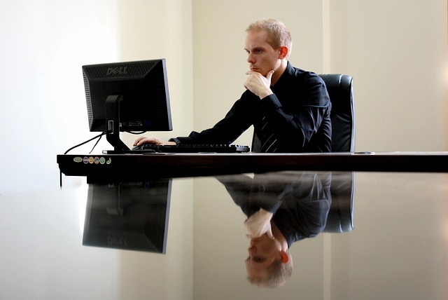 Person working at a desk with a computer in a modern office