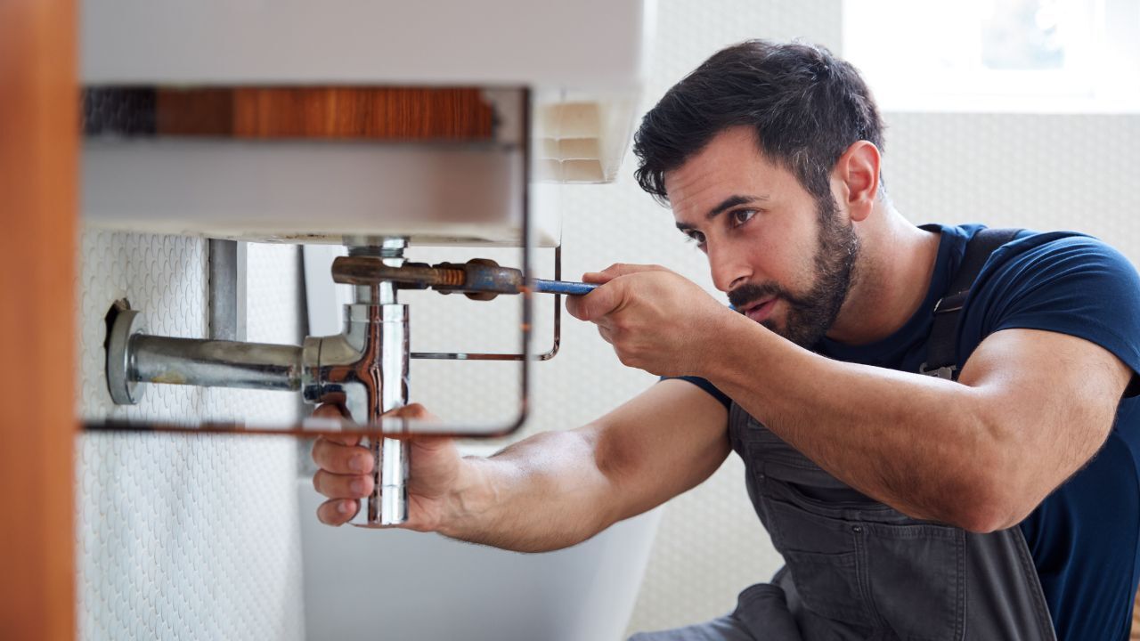 Technician repairing a plumbing leak