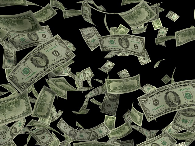 Cash raining over black background.