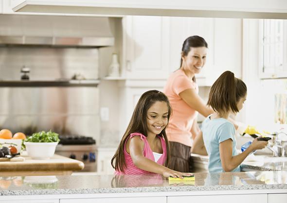 Image of a mother and her two kids cleaning their kitchen